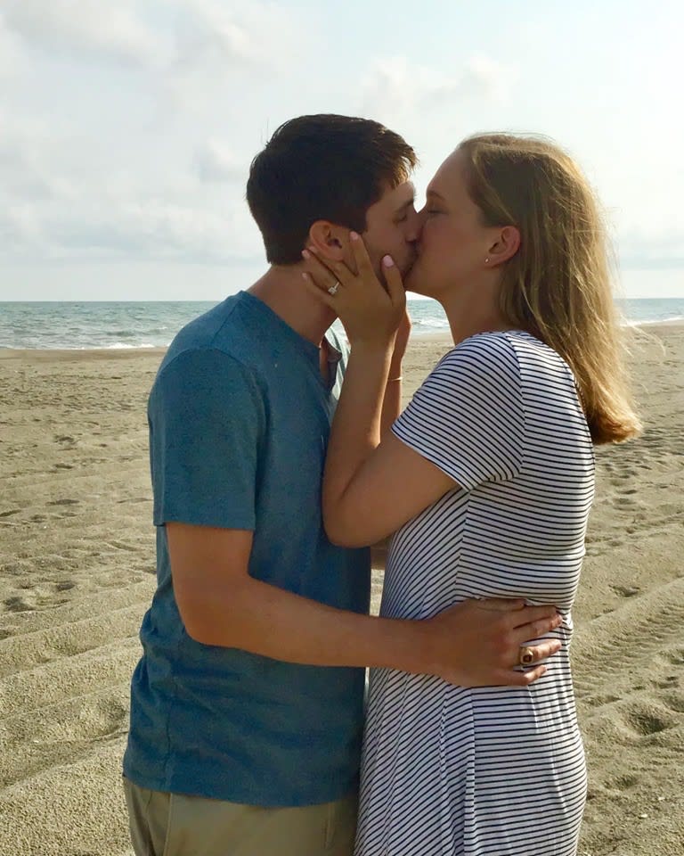 Couple celebrating an engagement on Holden Beach