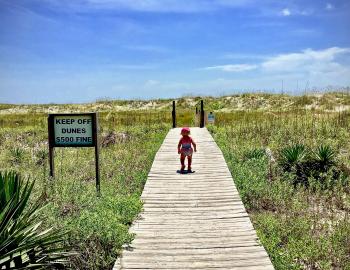 toddler walking boardwalk to holden beach