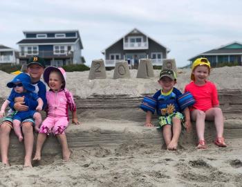 kids in the sand on holden beach