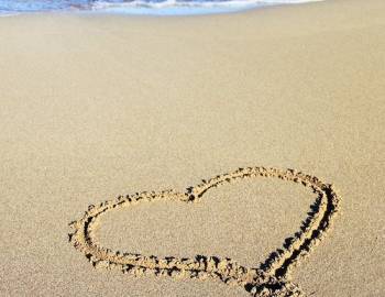 heart drawn in sandy beach