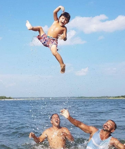 kid-playing-in-water-with-adults